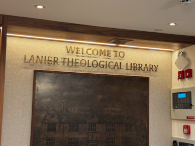 Welcome sign at tithe barn library reception desk.
